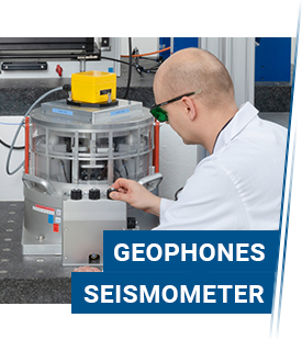 Measurement technician on a low-frequency vibration exciter with a mounted geophone